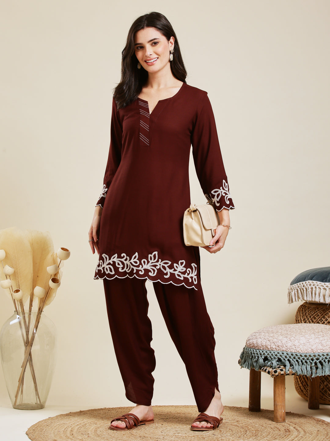 Woman wearing a maroon outfit with white embroidery in a room setting. Coffee Rayon Embroidered Co-ord Set for Women