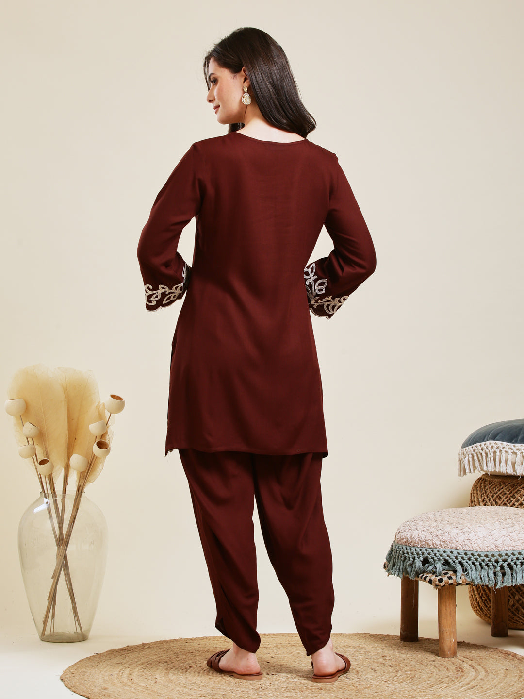 Woman wearing a maroon kurta with harem pants in a minimalistic room. Coffee Rayon Embroidered Co-ord Set for Women